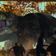 A drive-in full of people being terrorized by a t-rex.